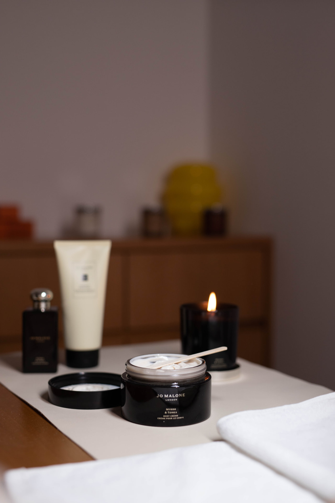 Jo Malone body crème and candle on a treatment bed