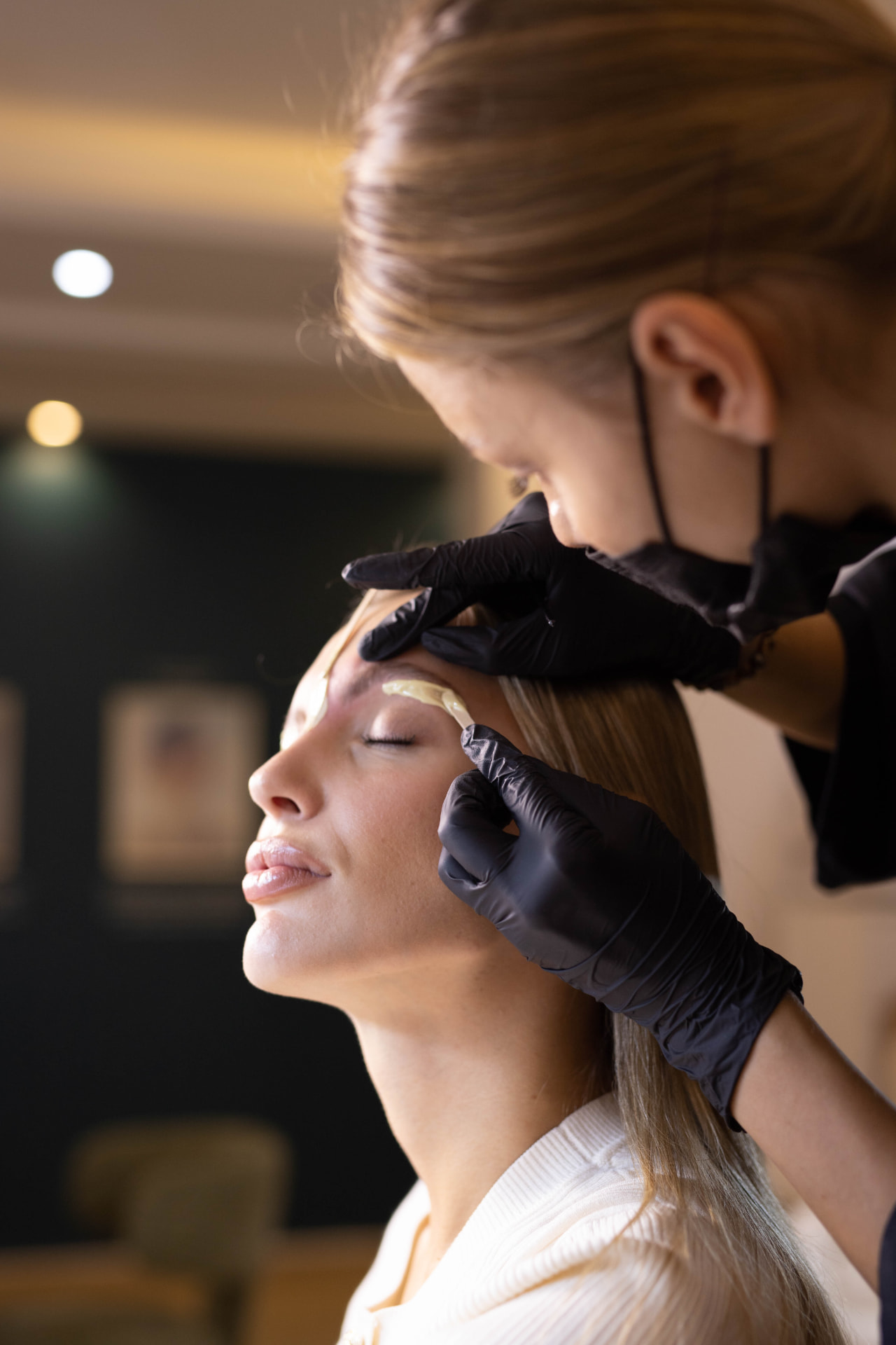Brow shaping with warm wax during a treatment